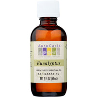 Bottle of clear essential oil, surrounded by fresh eucalyptus leaves.