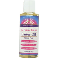 A bottle of Castor Oil with dropper, surrounded by castor seeds and leaves.